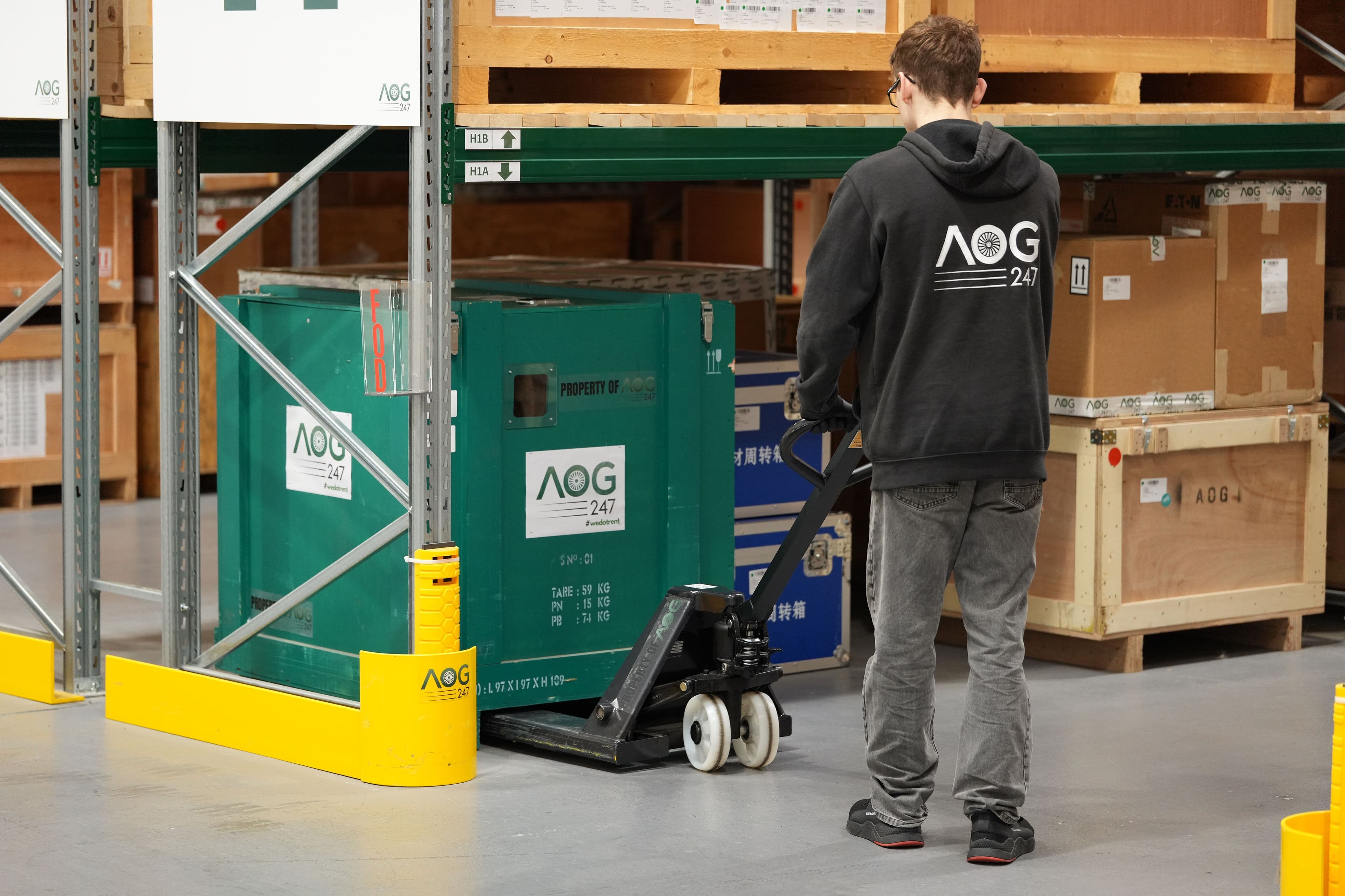 AOG-247 warehouse staff moving inventory on a pallet truck