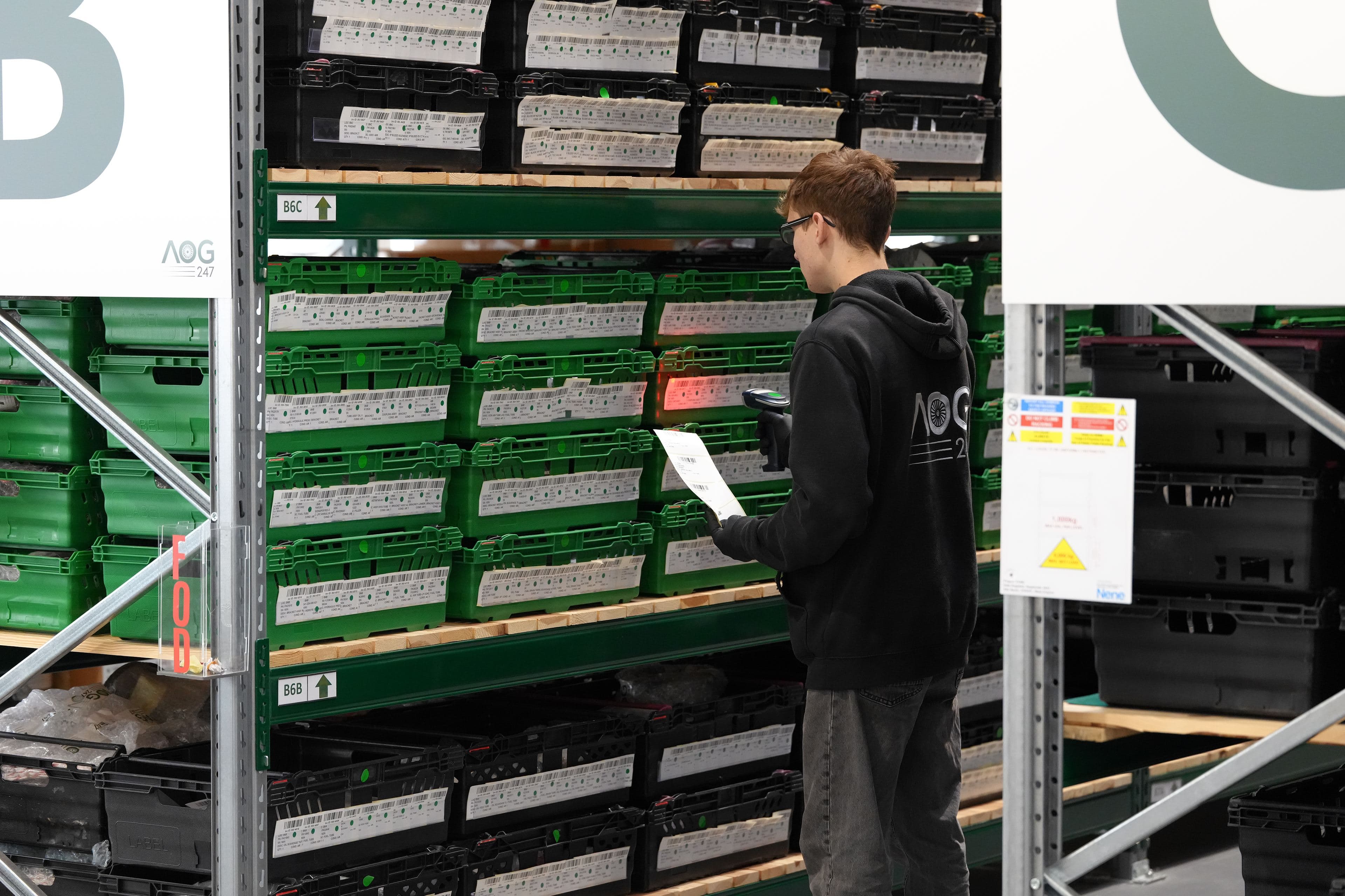 AOG-247 staff scanning USM parts bins in the warehouse
